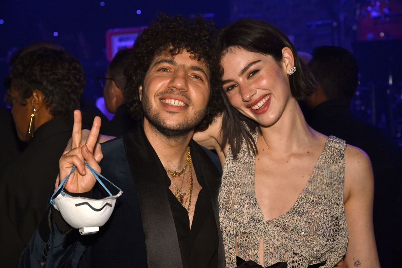 Smiling couple posing at event together – Duo Desire fun dating vibe.