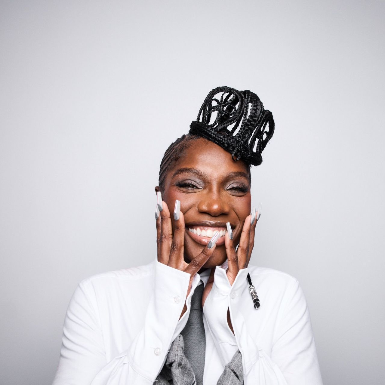 Smiling woman with braided crown hairstyle – Duo Desire bold love expression vibe.