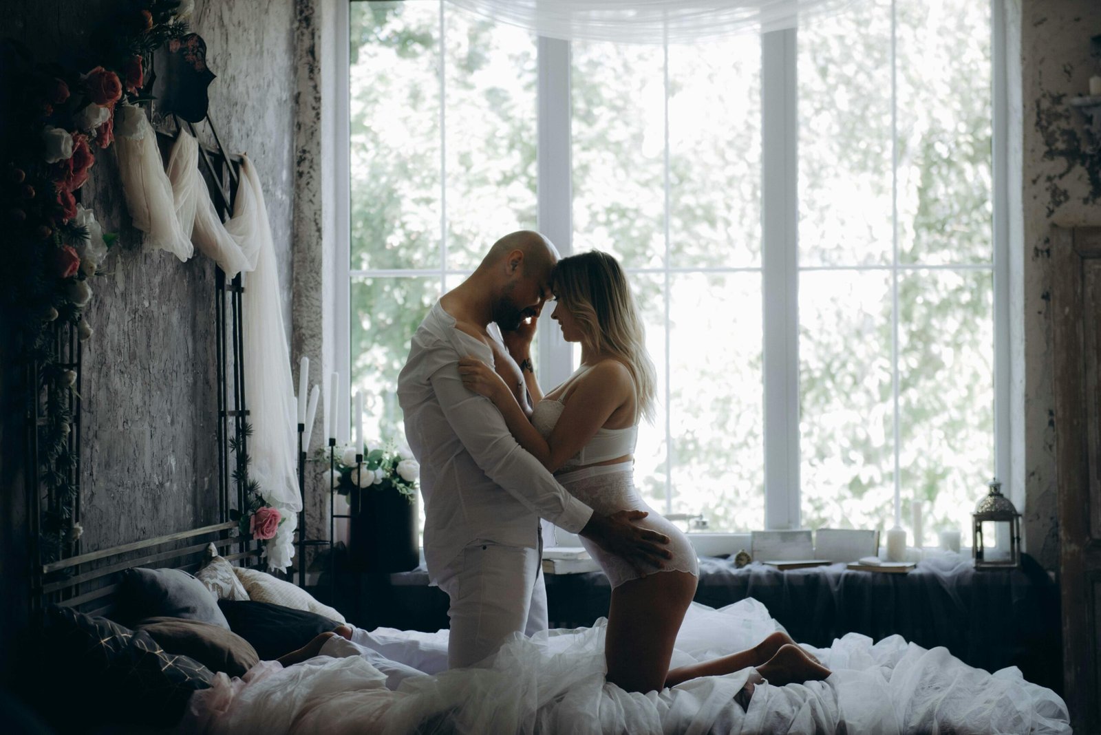 Romantic couple in intimate moment on bed, sunlight pouring in — Duo Desire.