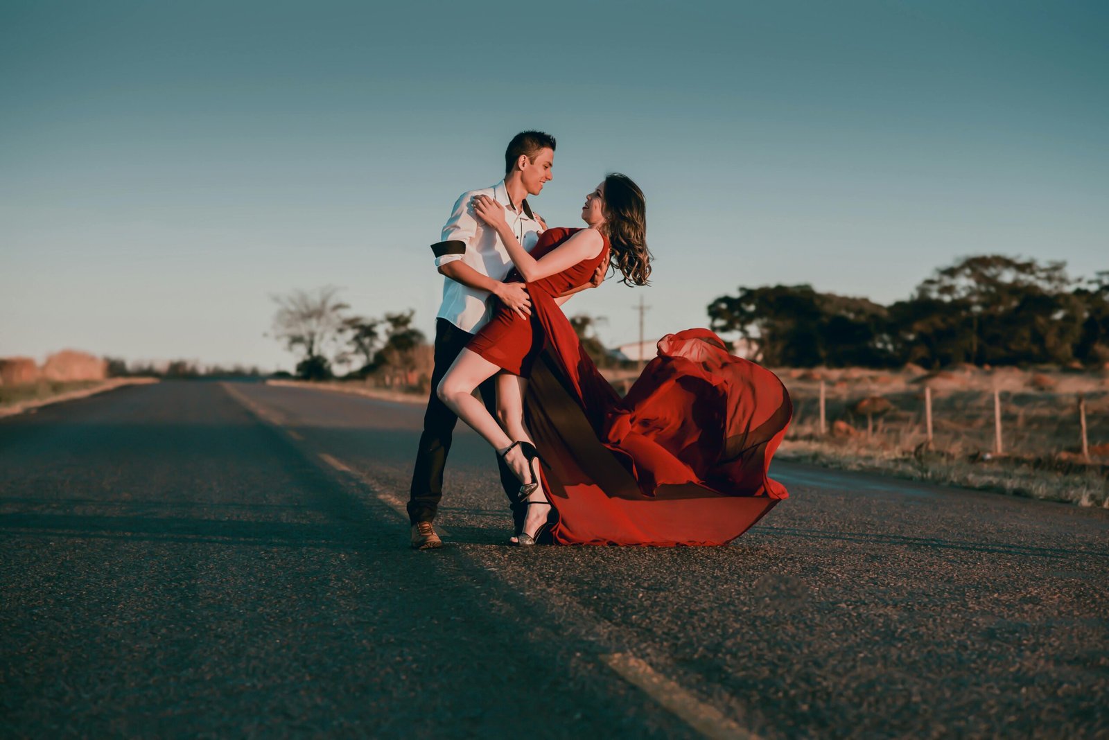Couple dancing on road at sunset, full of passion — Duo Desire.