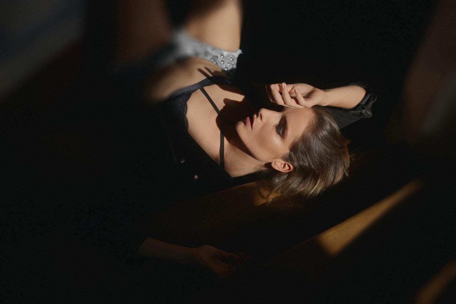 Woman lying in soft light, deep in thought, from Duo Desire.